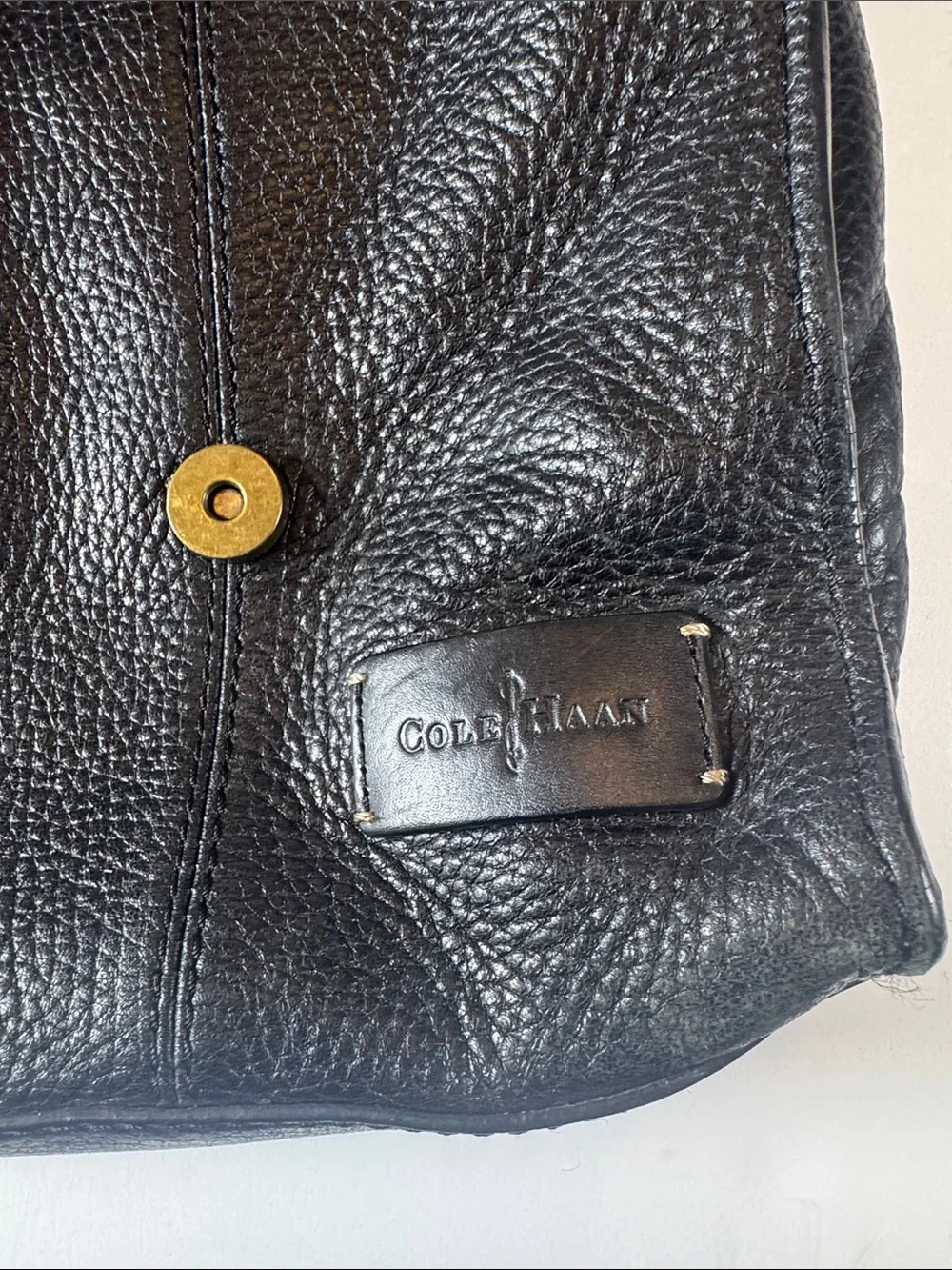 Cole Haan Black Leather Messenger Bag with Brass Accents